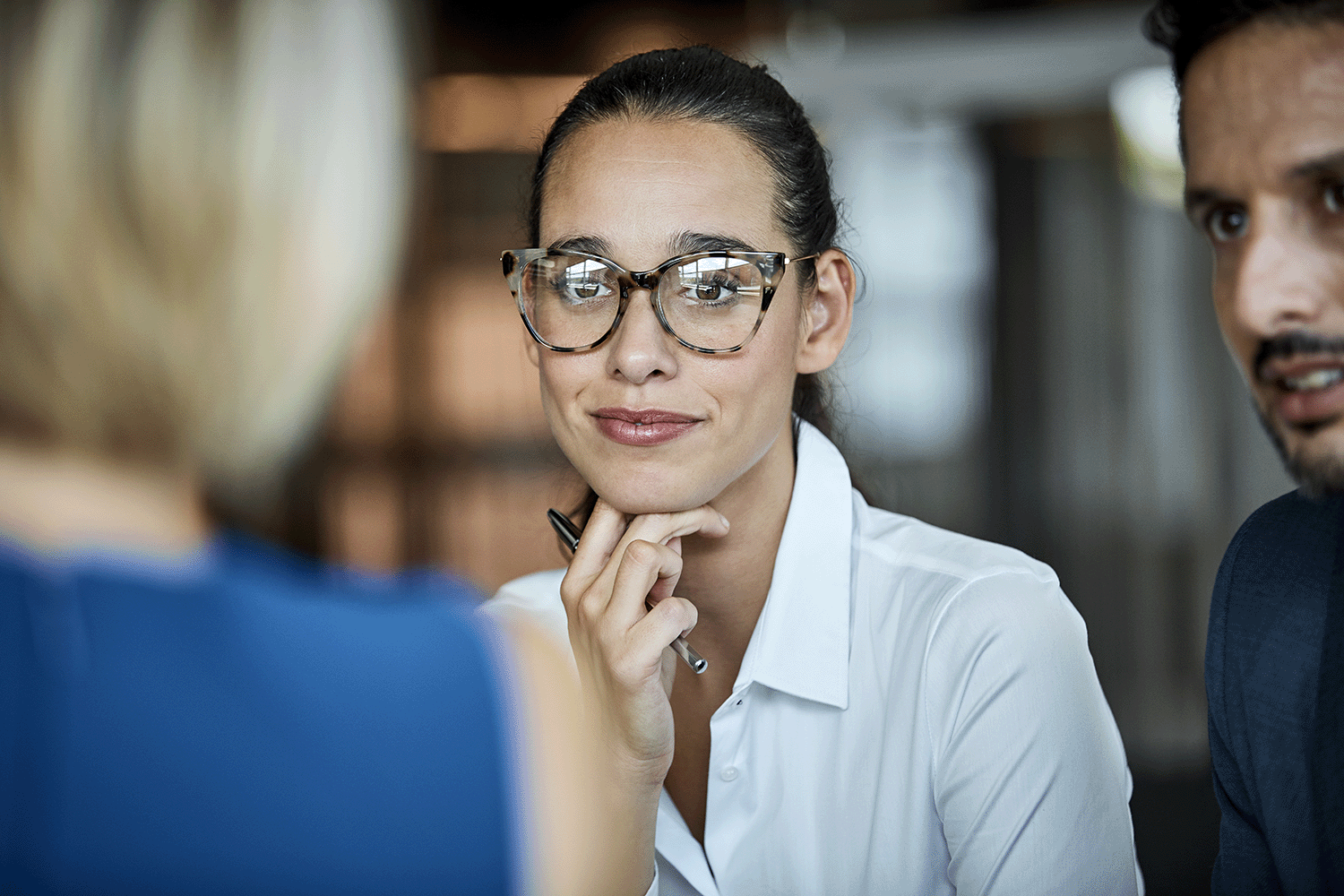 Focus on a woman looking at another person who is out of focus
